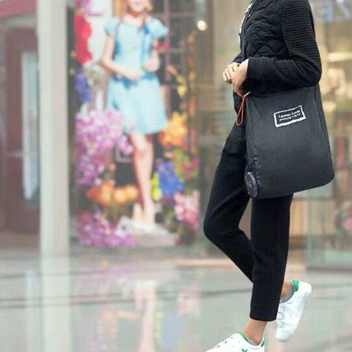 persona caminado por la calle usando bolsa plegable 